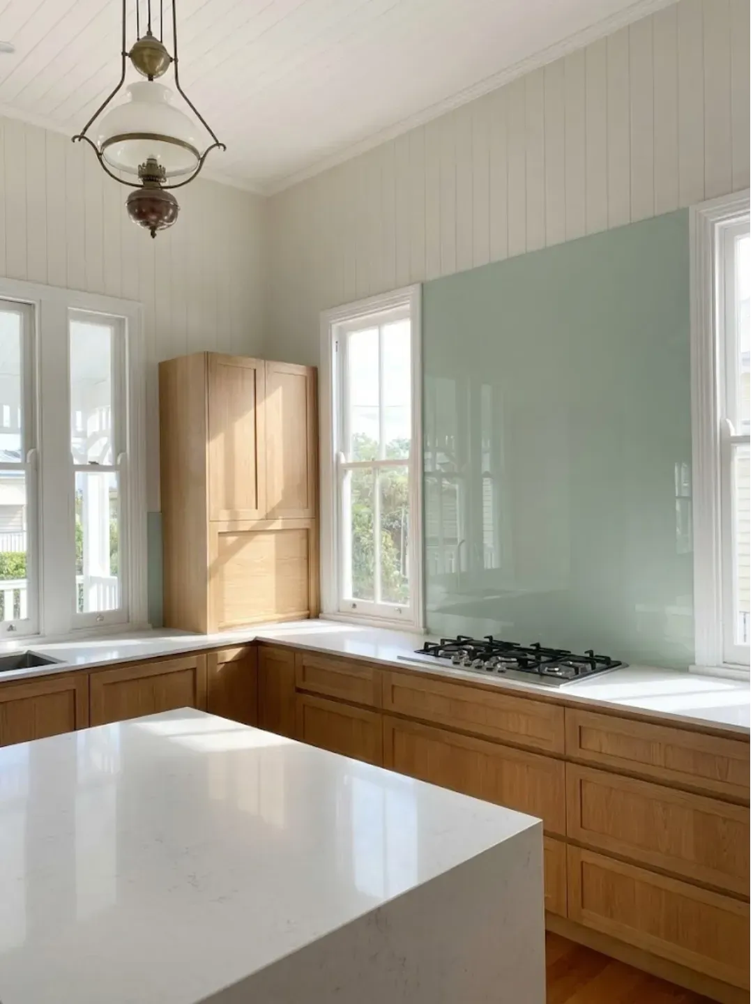 Custom coloured glass splashbacks Teneriffe with precision cut-outs for power points and millimetre-perfect fit.